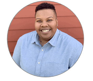Headshot of a black woman with short hair wearing a pale blue button-up shirt