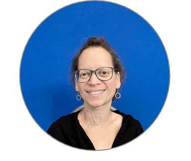 Headshot of a white woman wearing glasses and a black cardigan